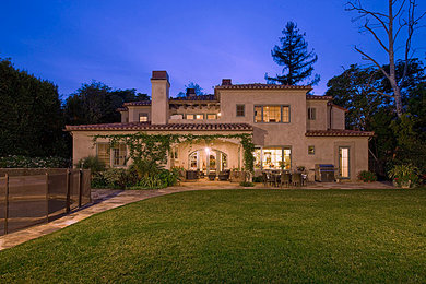 Example of a large tuscan beige two-story mixed siding exterior home design in Los Angeles