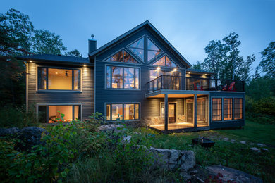 Inspiration for a large coastal gray two-story vinyl exterior home remodel in Other with a shingle roof