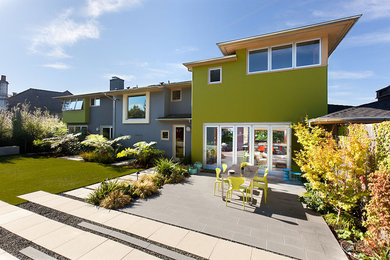 Example of a large trendy green two-story concrete exterior home design in San Francisco