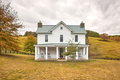 Mid-sized farmhouse white two-story mixed siding exterior home idea in Other with a metal roof