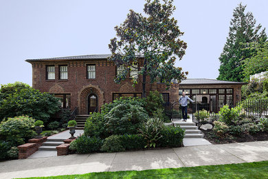 Example of a classic exterior home design in Seattle with a hip roof