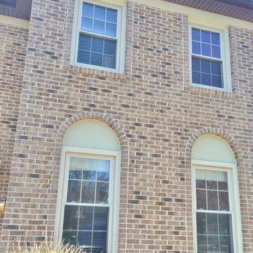 Brick Front Home with Beige Arch Top Hardie Panels, London Brown Soffit & Fascia