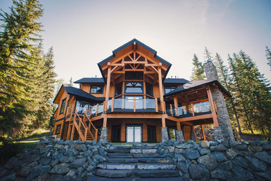 Inspiration for a large retro detached house in Vancouver with three floors, wood cladding, a lean-to roof and a shingle roof.