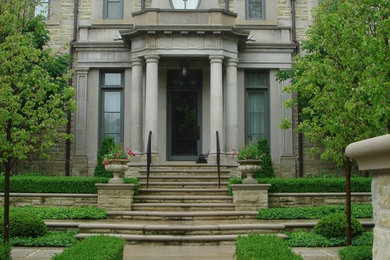 Large elegant beige two-story stone house exterior photo in Toronto with a shed roof and a tile roof