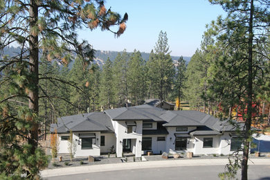 Inspiration for a large transitional white two-story stucco house exterior remodel in Seattle with a hip roof and a mixed material roof