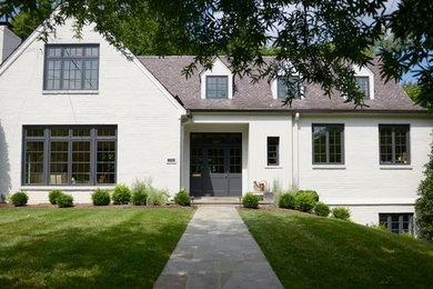 Large elegant white two-story brick exterior home photo in DC Metro with a shingle roof