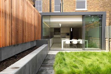 Inspiration for a contemporary brick detached house in London with a flat roof.