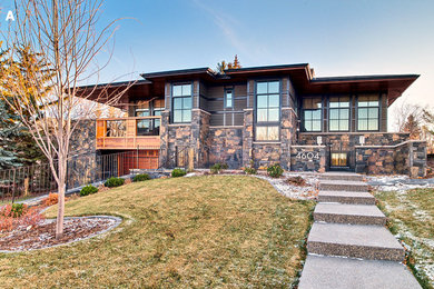 Large and brown traditional two floor detached house in Calgary with mixed cladding.