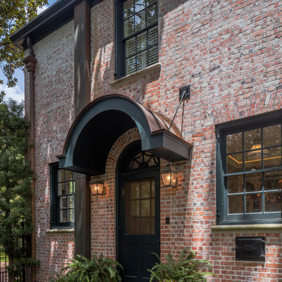 Inspiration for a mid-sized timeless two-story brick exterior home remodel in Houston with a hip roof