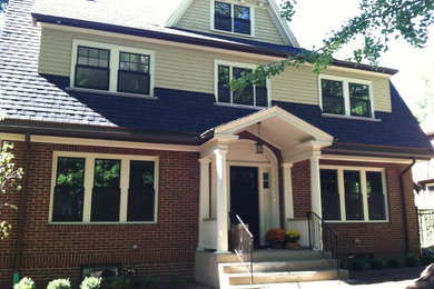 Inspiration for a mid-sized timeless beige three-story mixed siding gable roof remodel in Boston