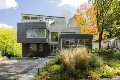Inspiration for a mid-sized contemporary brown three-story mixed siding exterior home remodel in Boston with a shed roof