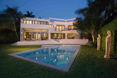 Trendy white two-story exterior home photo in Miami