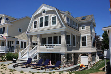 Inspiration for a timeless beige three-story mixed siding exterior home remodel in Providence