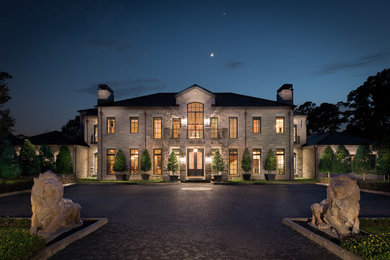 Design ideas for an expansive and gey classic two floor house exterior in Houston with stone cladding.