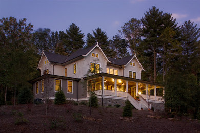 Example of a large classic white two-story vinyl exterior home design in Other with a shingle roof