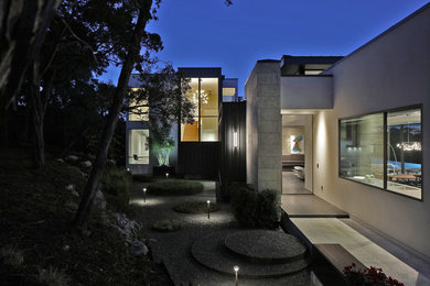 Example of a large trendy black two-story metal exterior home design in Austin with a metal roof