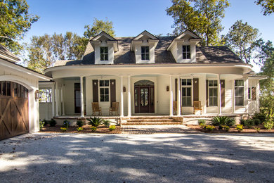 Example of a large classic white two-story vinyl gable roof design in Charleston