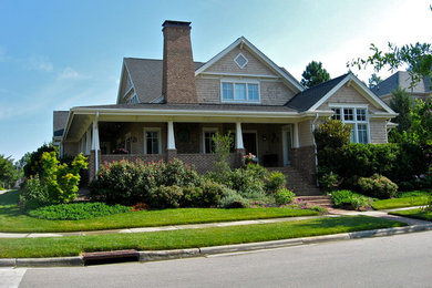 Example of a mid-sized classic beige two-story mixed siding gable roof design in Raleigh