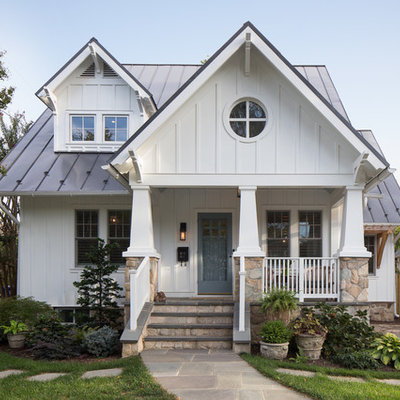 Large arts and crafts white two-story concrete fiberboard exterior home photo in DC Metro with a metal roof