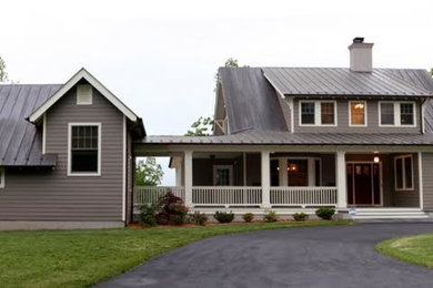 Example of a large classic beige two-story wood exterior home design in Other