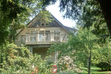This is an example of a large and beige traditional two floor detached house in Toronto with wood cladding, a pitched roof and a shingle roof.