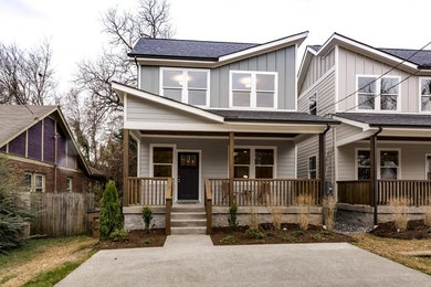 Inspiration for a mid-sized modern gray two-story concrete fiberboard house exterior remodel in Nashville with a clipped gable roof and a shingle roof