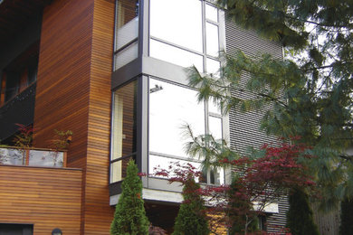 Example of a mid-sized minimalist gray two-story wood exterior home design in Vancouver