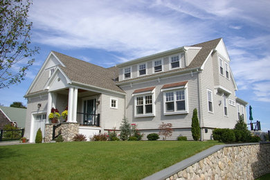 Large elegant gray two-story wood exterior home photo in Boston with a shingle roof