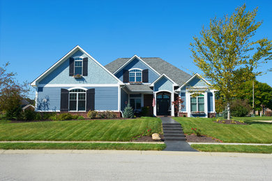Example of an arts and crafts blue two-story mixed siding gable roof design in Indianapolis