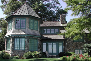 Example of a mid-sized ornate gray two-story mixed siding exterior home design in New York with a shingle roof