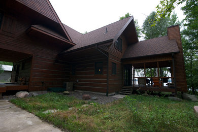 Large mountain style brown two-story wood gable roof photo in Minneapolis