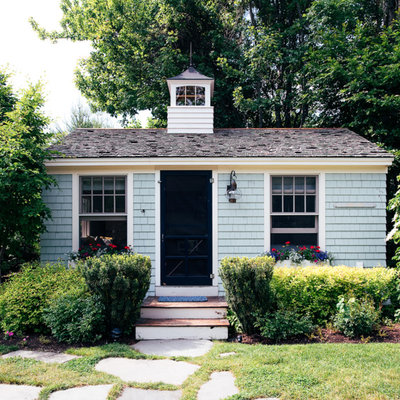 Example of a small beach style blue one-story wood tiny house design in Portland Maine with a hip roof and a shingle roof