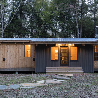 Inspiration for a contemporary brown one-story mixed siding house exterior remodel in Burlington with a shed roof and a metal roof