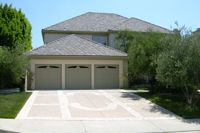 This is an example of a beige and medium sized traditional two floor render house exterior in Los Angeles with a hip roof.