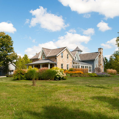 Inspiration for a large farmhouse mixed siding exterior home remodel in Toronto