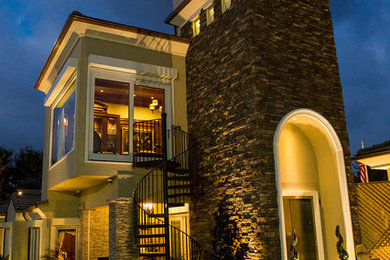 This is an example of a medium sized and beige two floor house exterior in Los Angeles with mixed cladding.