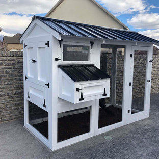 Example of a small farmhouse white wood gable roof design in Other with a metal roof