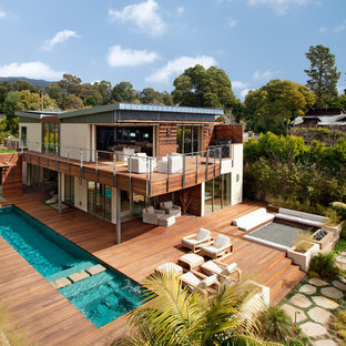 Inspiration for a medium sized and white contemporary two floor house exterior in Santa Barbara with mixed cladding and a lean-to roof.