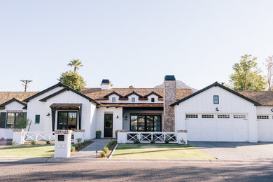 Example of a large cottage white one-story wood house exterior design in Phoenix with a shingle roof