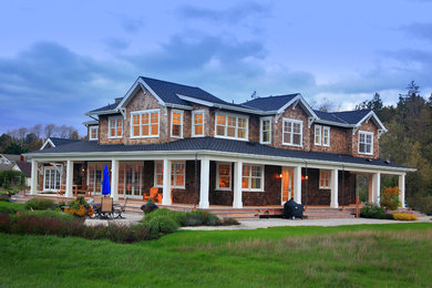 Example of a large mountain style brown two-story wood house exterior design in Seattle with a hip roof and a shingle roof