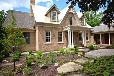 Country beige two-story brick gable roof photo in Ottawa