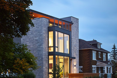 Inspiration for a large modern gray three-story mixed siding exterior home remodel in Ottawa with a metal roof