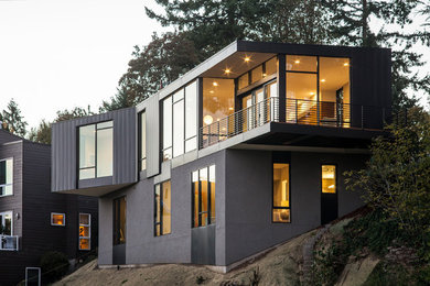 Mid-sized modern black two-story metal exterior home idea in Portland with a metal roof