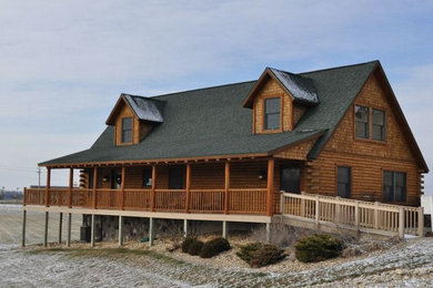 Example of a large mountain style brown two-story wood exterior home design in St Louis