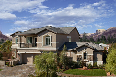 Example of a large tuscan beige two-story stucco exterior home design in Las Vegas