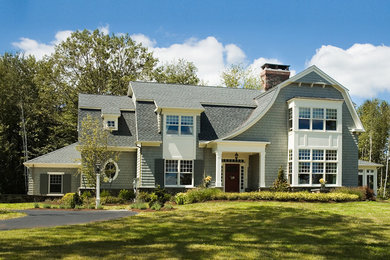 Large arts and crafts gray two-story wood house exterior photo in New York with a gambrel roof and a shingle roof