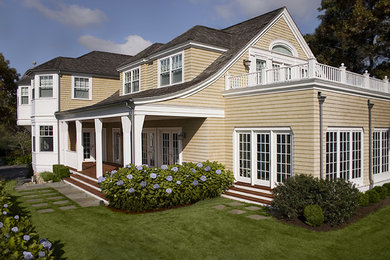 Example of a three-story wood exterior home design in Boston