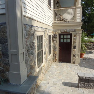 Cape Cod Inn with New England Stone Cladding, Retaining Walls, and Water Feature