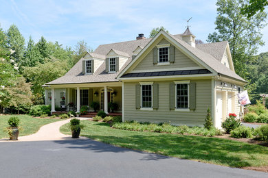 Inspiration for a mid-sized timeless beige two-story vinyl exterior home remodel in Other with a shingle roof