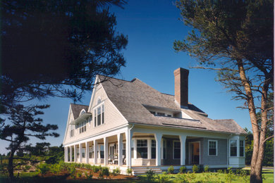 Example of a large classic gray two-story wood exterior home design in Boston with a hip roof